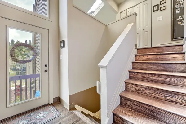a view of entryway and hall with wooden floor