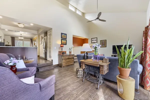 a living room with furniture and a potted plant