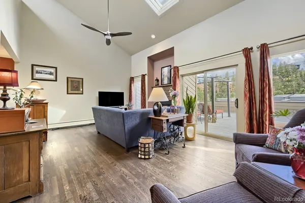 a living room with furniture a large window and a flat screen tv