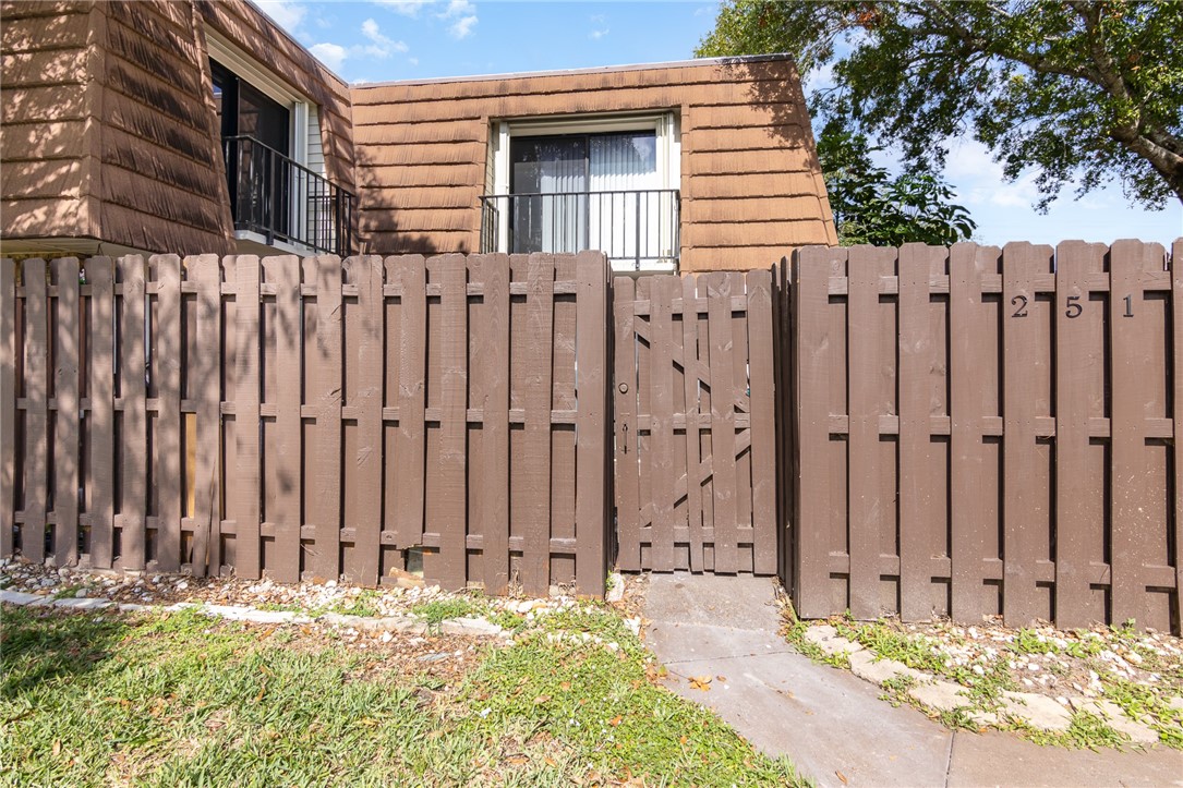 a view of a backyard with wooden fence