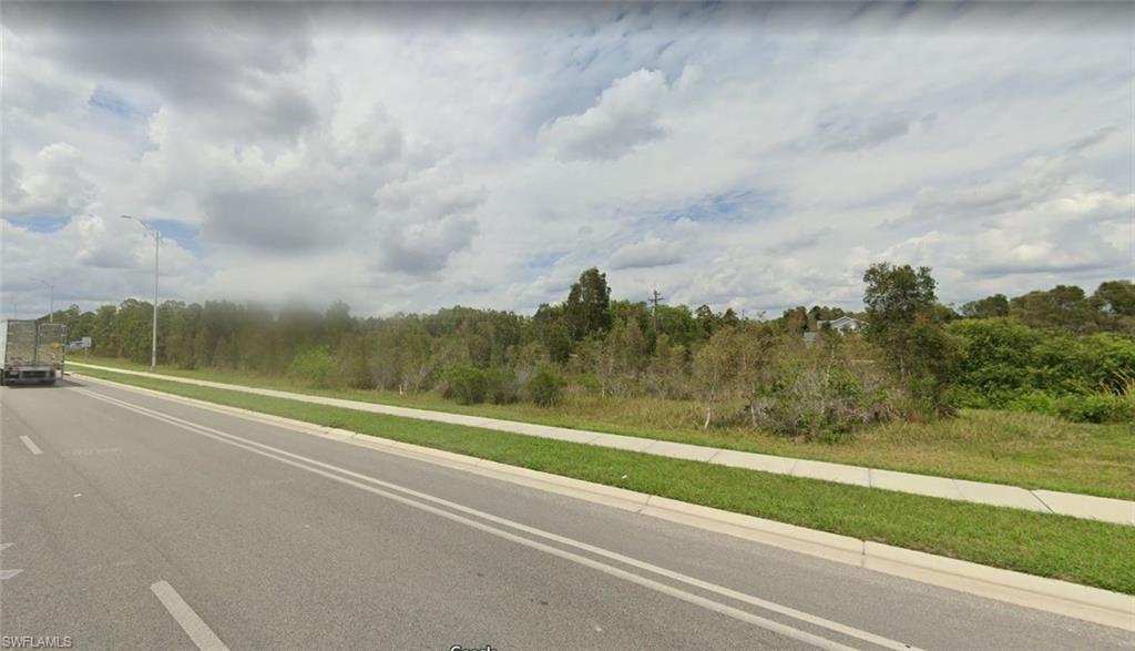 2664 Meadow Road Lehigh Acres, FL 33974 - Photo 3 of 4 a view of a yard and ocean view