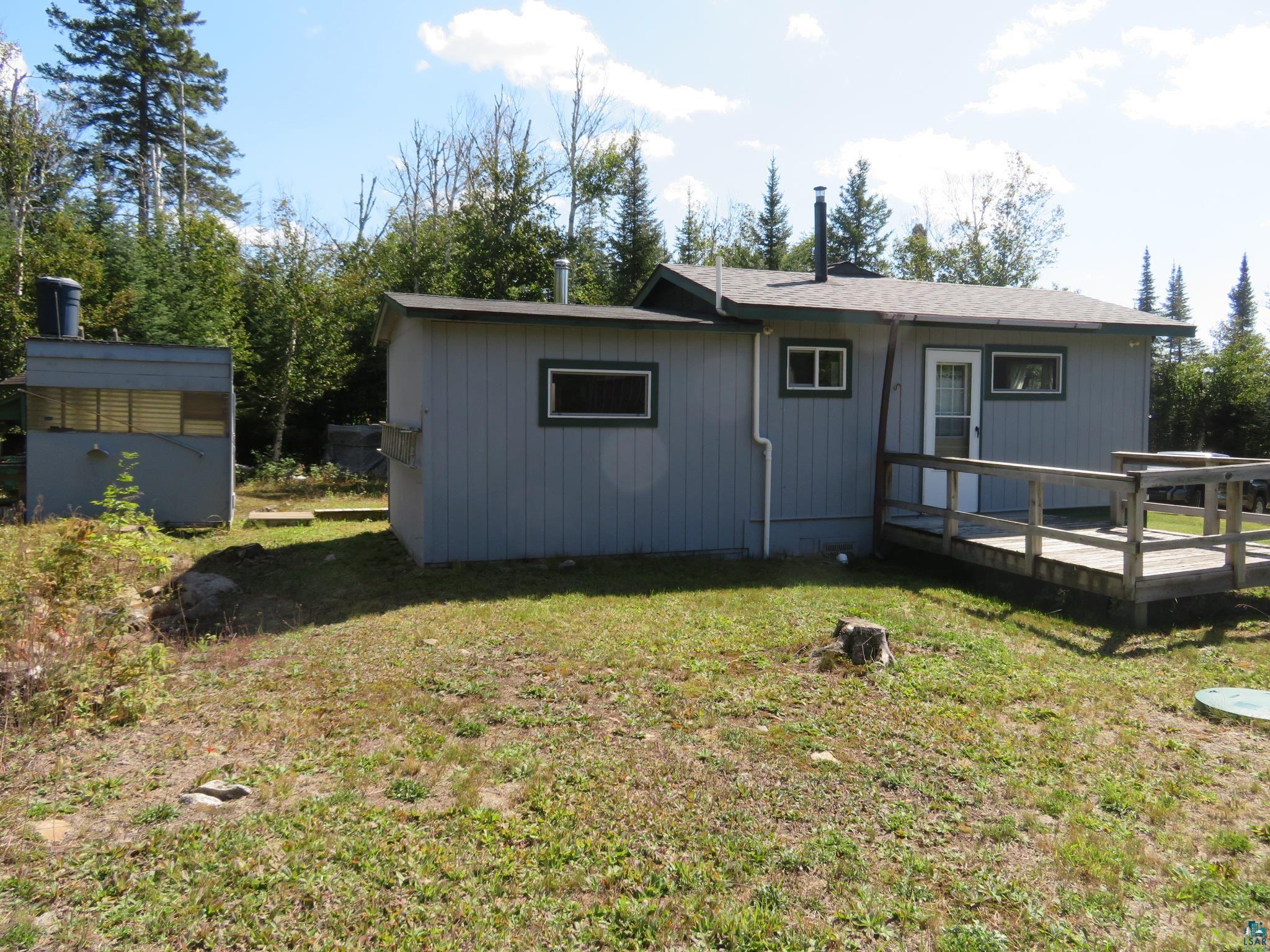 1268 Tom Lake Road Hovland, MN 55606 - Photo 43 of 56 Back of property with a deck and a yard