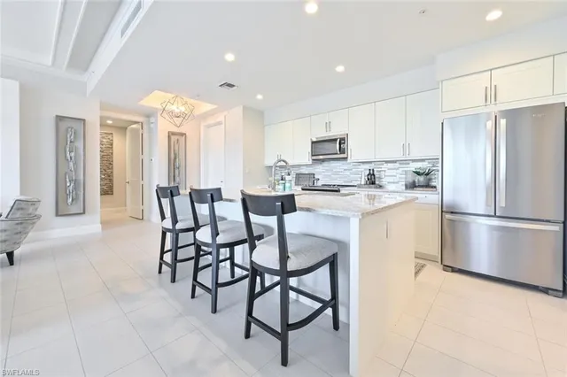 a kitchen with granite countertop a sink and cabinets