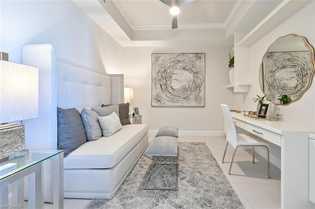 1111 Central Avenue, Unit 303 Naples, FL 34102 - Photo 16 of 50 a living room with furniture and a painting on the wall