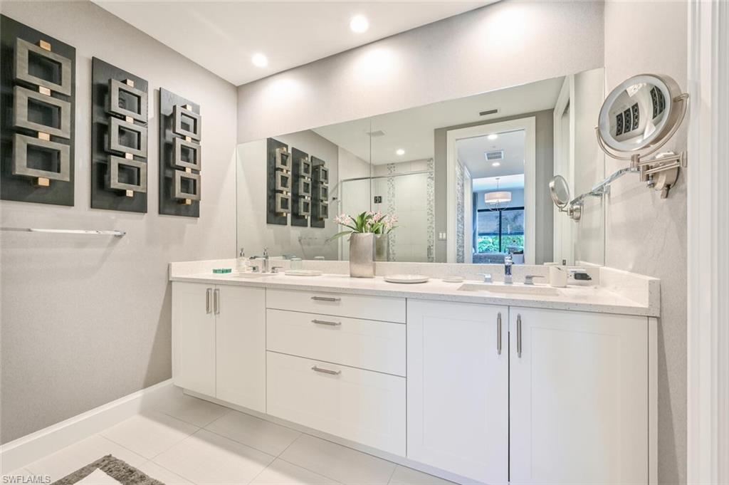 1111 Central Avenue, Unit 303 Naples, FL 34102 - Photo 21 of 50 a bathroom with a sink and a mirror
