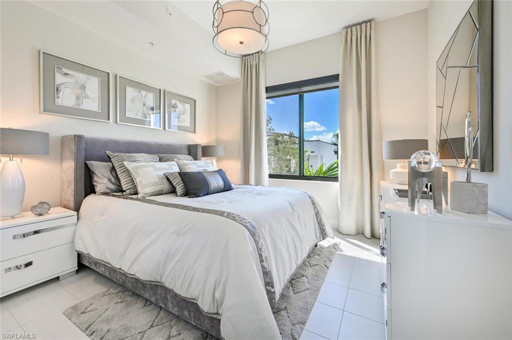 1111 Central Avenue, Unit 303 Naples, FL 34102 - Photo 22 of 50 a bedroom with a bed and a large window
