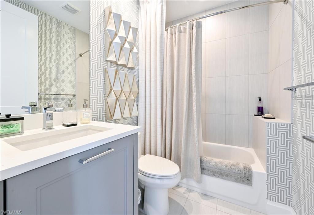 1111 Central Avenue, Unit 303 Naples, FL 34102 - Photo 24 of 50 a bathroom with a sink a toilet and shower