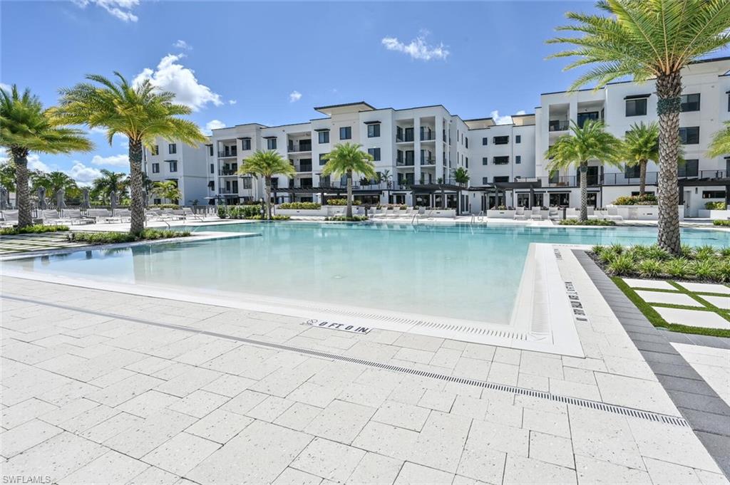 1111 Central Avenue, Unit 303 Naples, FL 34102 - Photo 31 of 50 a view of a building with outdoor space and sitting area