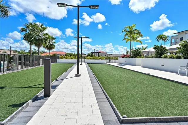 a swimming pool with outdoor seating and yard