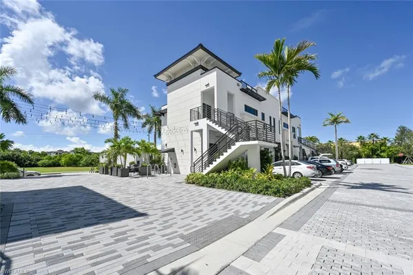a large white kitchen with kitchen island a stove a sink and a dishwasher