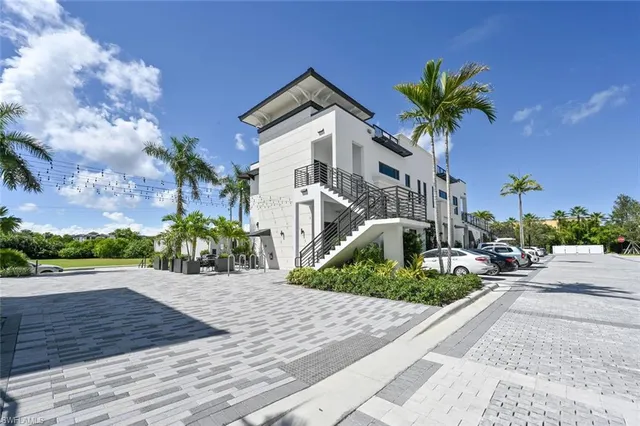a large white kitchen with kitchen island a stove a sink and a dishwasher