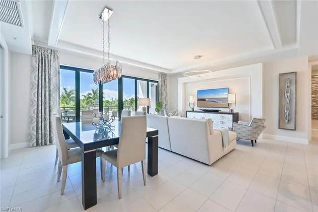 a living room with furniture a large window and a flat screen tv
