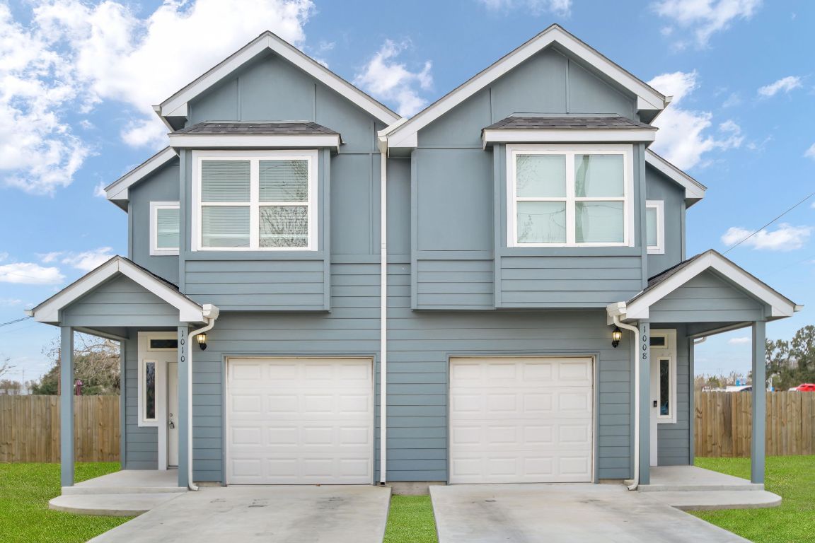 a front view of a house with garage