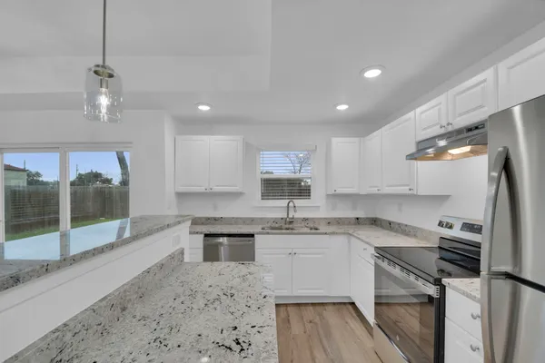 a kitchen with a sink stainless steel appliances and cabinets