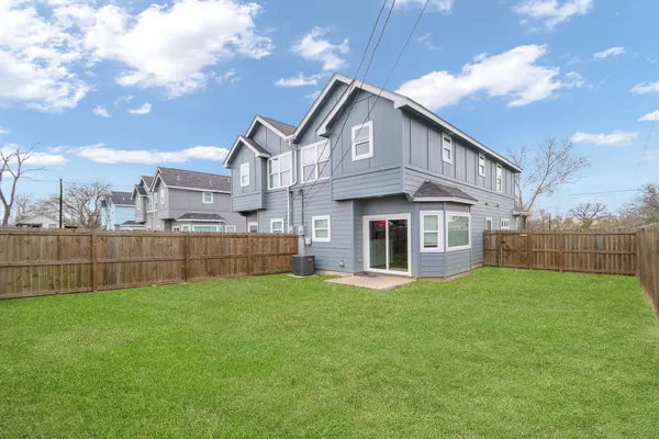 a view of a house with a yard and sitting area