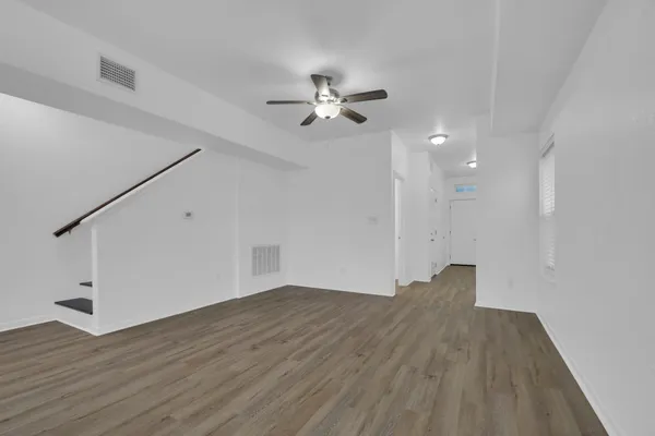 wooden floor in an empty room with a window