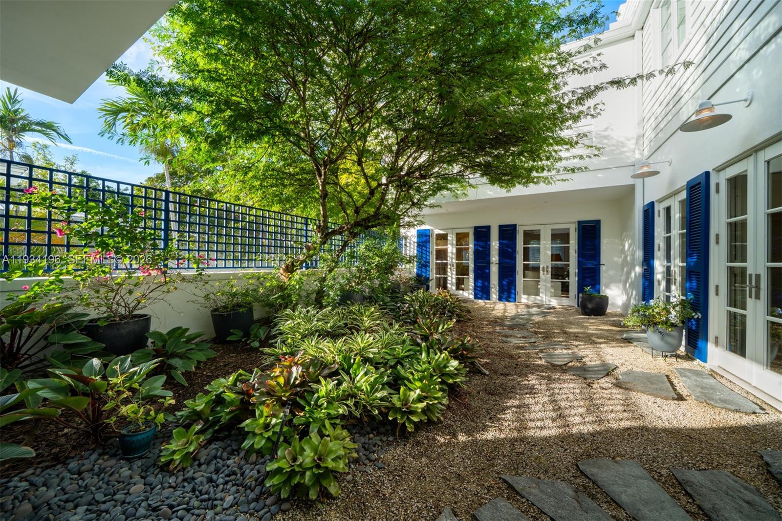 100 Cape Florida Drive Key Biscayne, FL 33149 - Photo 24 of 68 a view of a house with a tree and garden