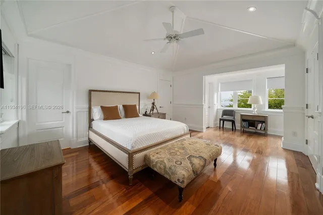 a view of a hallway with furniture and a bathroom
