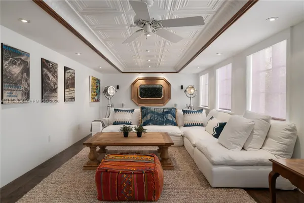 a view of a hallway with wooden floor and a cabinet