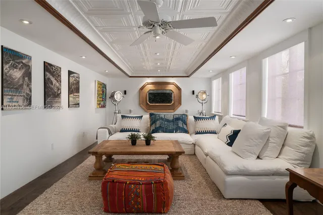 a view of a hallway with wooden floor and a cabinet