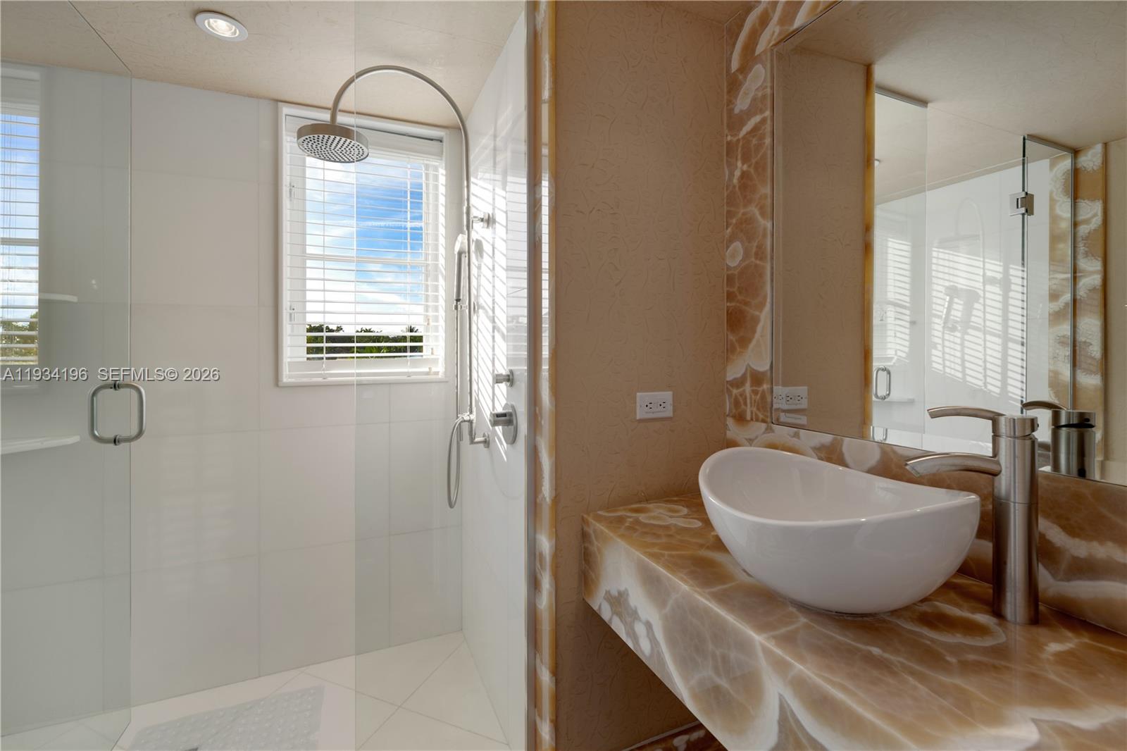 100 Cape Florida Drive Key Biscayne, FL 33149 - Photo 36 of 68 a bathroom with a sink and a mirror