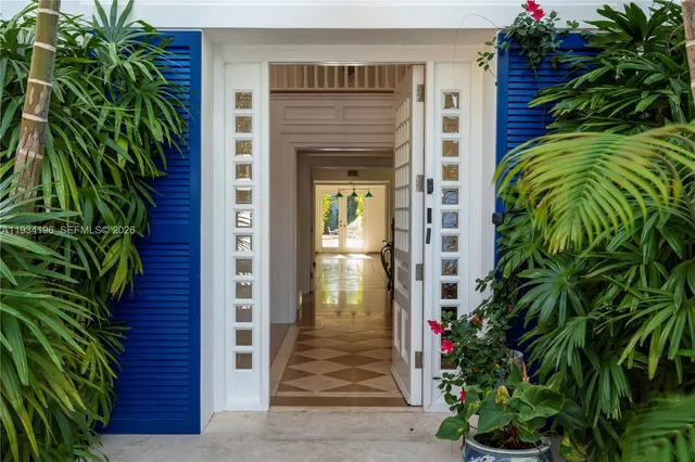 a view of a house with a yard and potted plants