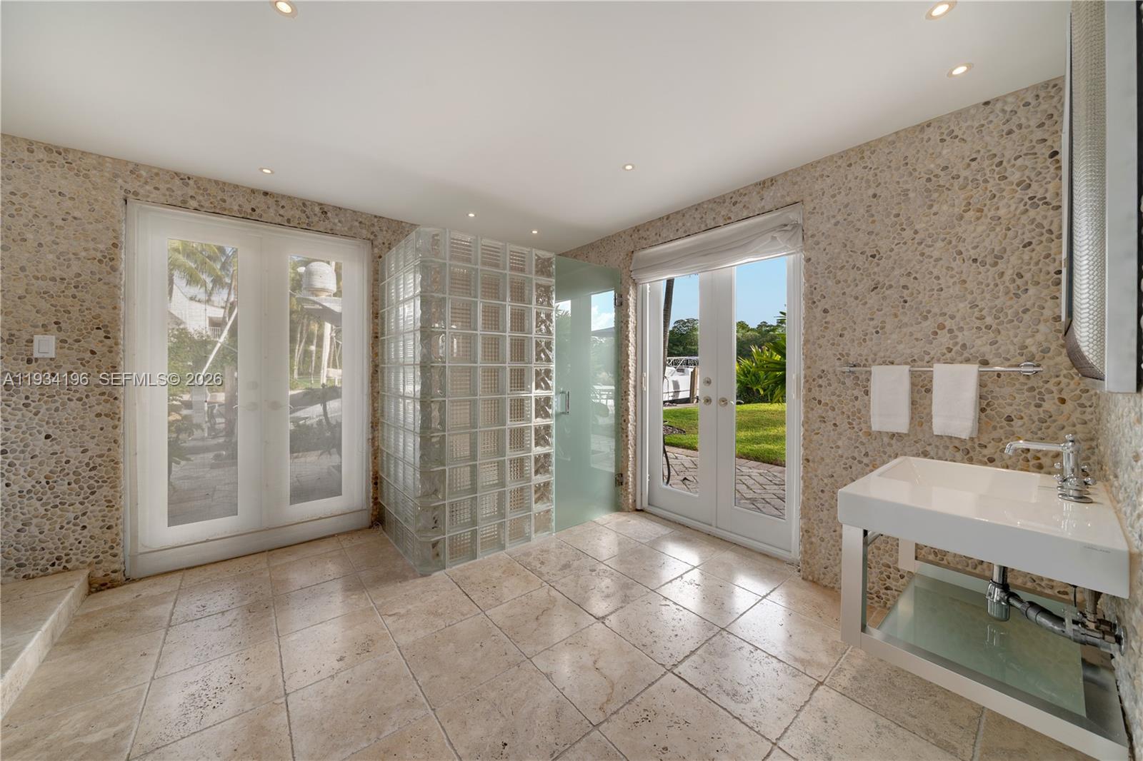 100 Cape Florida Drive Key Biscayne, FL 33149 - Photo 43 of 68 a view of a hallway with furniture and a bathroom
