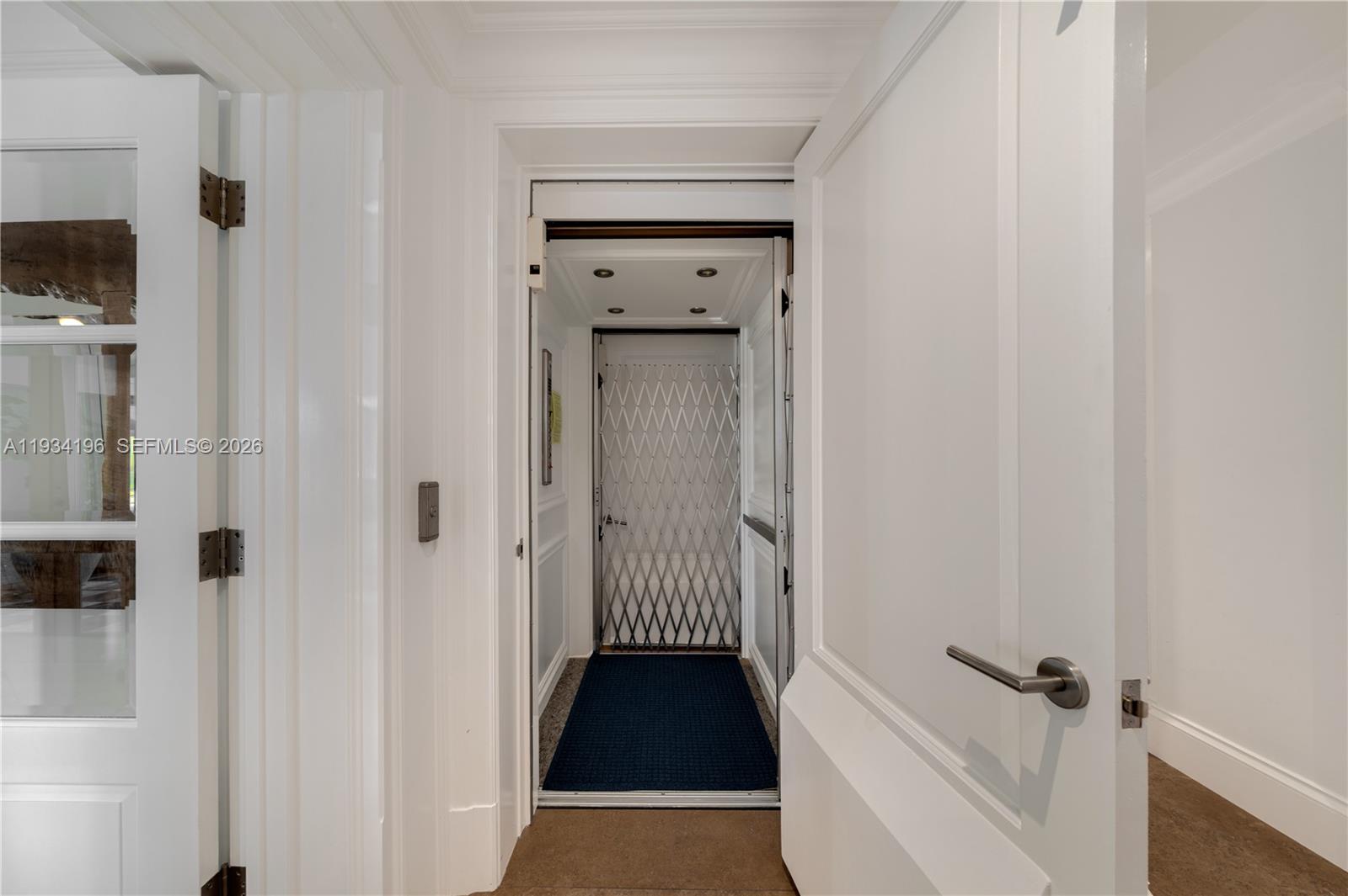 100 Cape Florida Drive Key Biscayne, FL 33149 - Photo 46 of 68 a view of a hallway with wooden floor and a cabinet