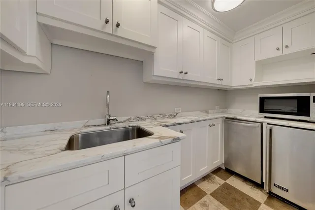 a view of a city with lots of residential buildings ocean and mountain view in back