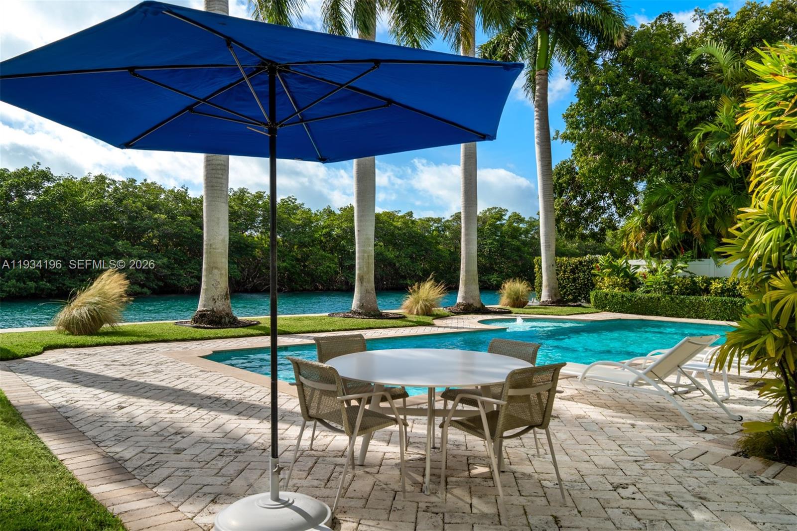 100 Cape Florida Drive Key Biscayne, FL 33149 - Photo 55 of 68 a view of pool with table and chairs under an umbrella