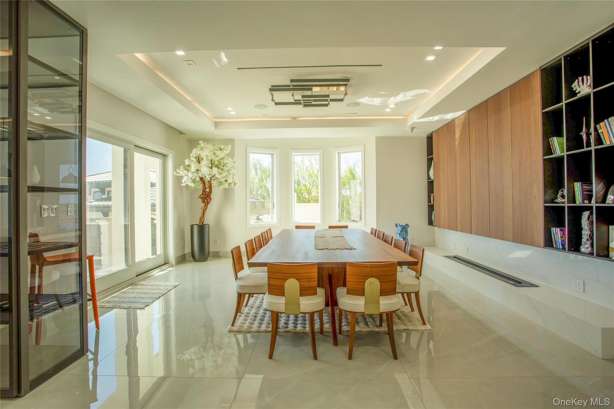 190 Curtis Road Woodmere, NY 11598 - Photo 8 of 45 Dining room with a raised ceiling and light tile patterned floors