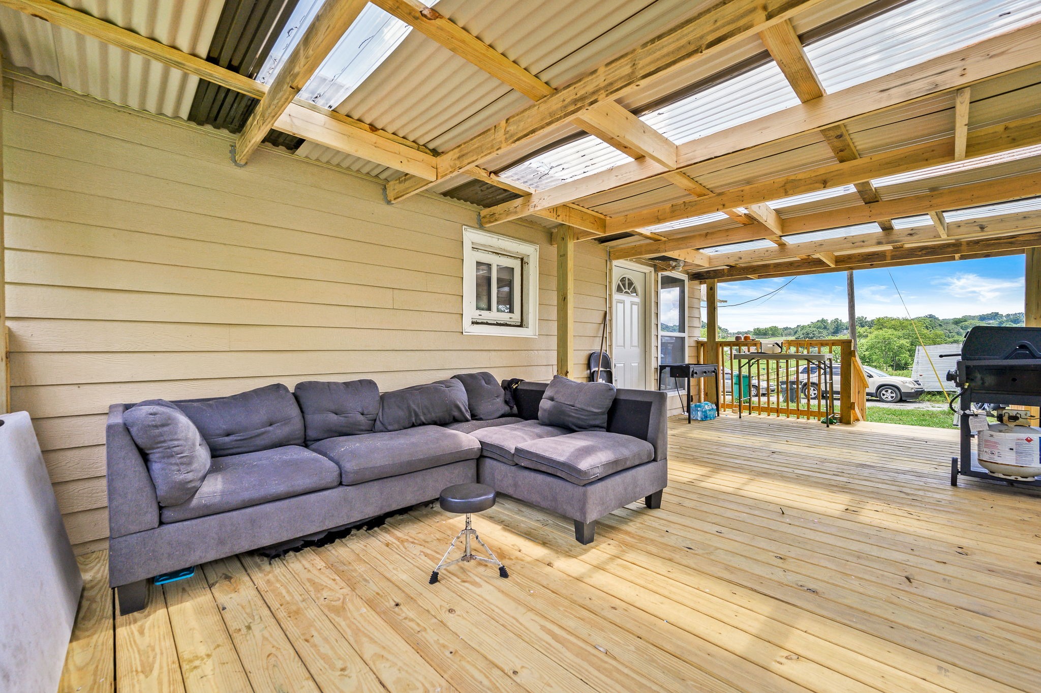 3198 Horn Springs Road Lebanon, TN 37087 - Photo 22 of 41 a view of a patio with couches chairs and wooden floor