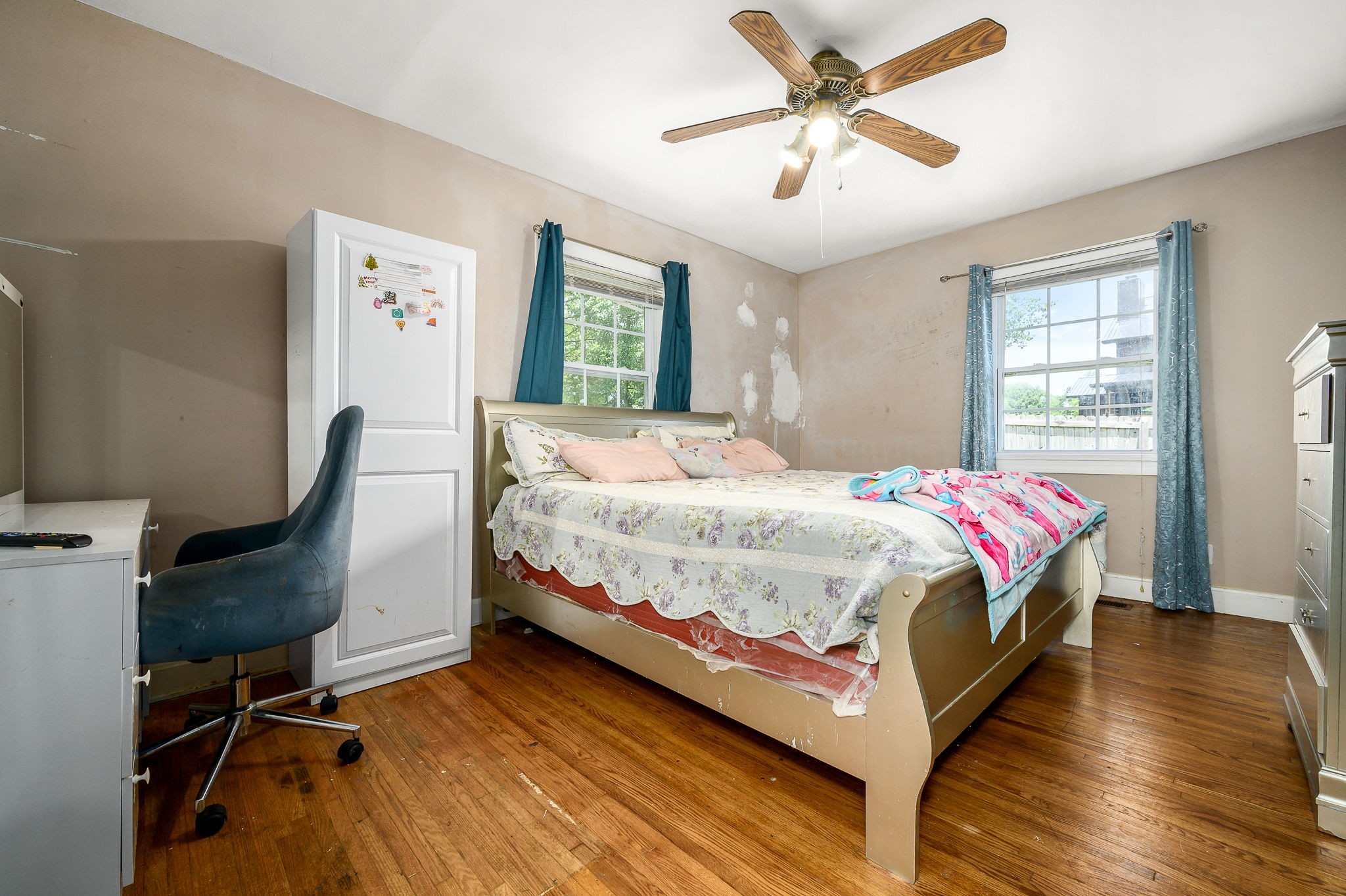 3198 Horn Springs Road Lebanon, TN 37087 - Photo 37 of 41 a bedroom with a bed a desk and chair with wooden floor