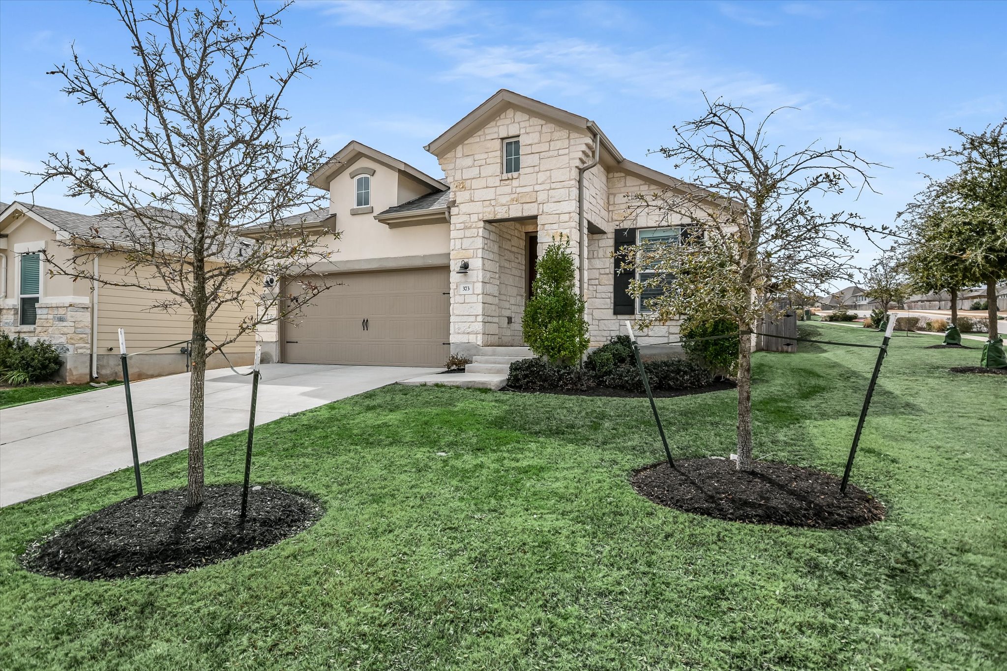 373 Victoria Peak Loop Dripping Springs, TX 78620 - Photo 1 of 1 a view of a house with a yard and a fountain
