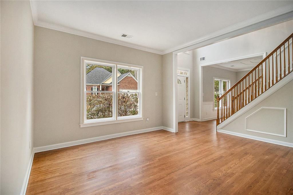 1463 Crescent Walk Decatur, GA 30033 - Photo 11 of 28 a view of an empty room with wooden floor and a window