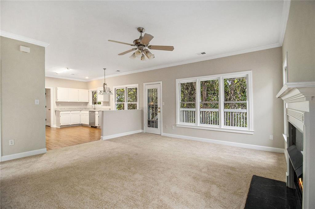 1463 Crescent Walk Decatur, GA 30033 - Photo 12 of 28 a view of a livingroom with a fireplace a ceiling fan and windows