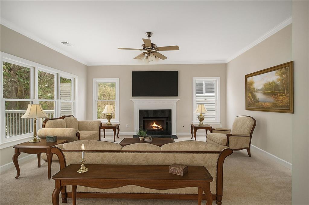 1463 Crescent Walk Decatur, GA 30033 - Photo 3 of 28 a living room with furniture a flat screen tv and a fireplace