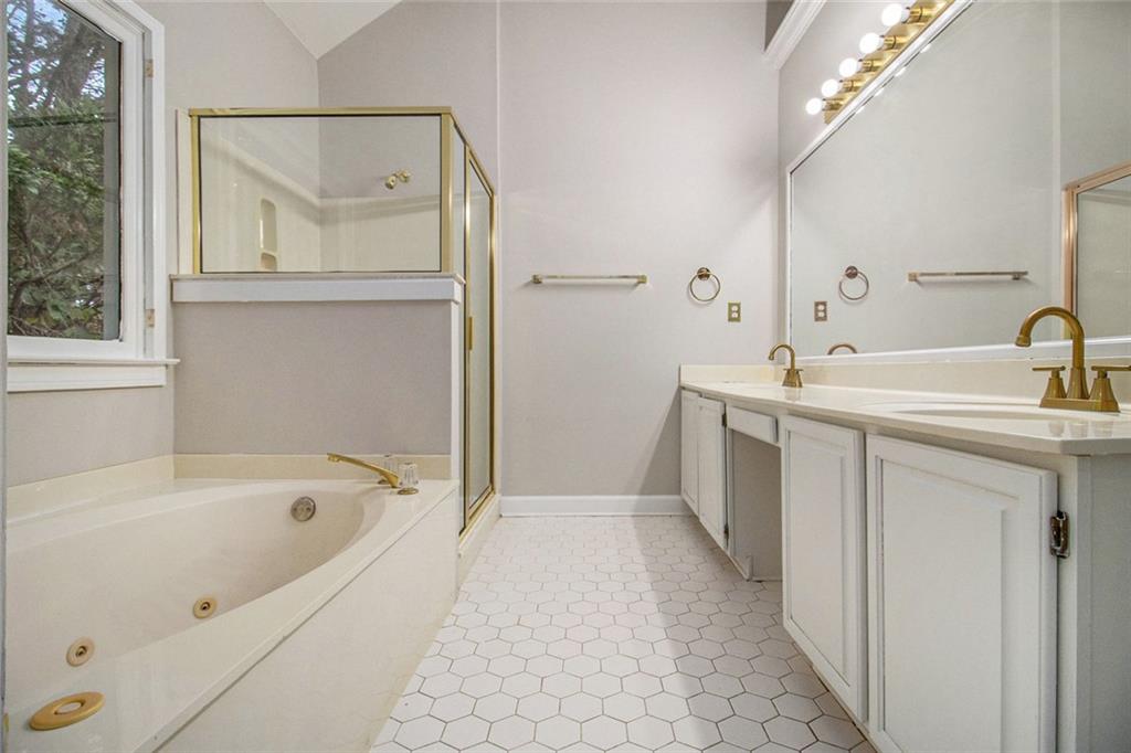 1463 Crescent Walk Decatur, GA 30033 - Photo 5 of 28 a bathroom with a bathtub a mirror a sink and vanity