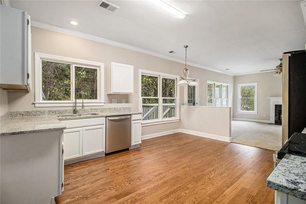 1463 Crescent Walk Decatur, GA 30033 - Photo 8 of 28 a kitchen with granite countertop a stove a sink and a refrigerator