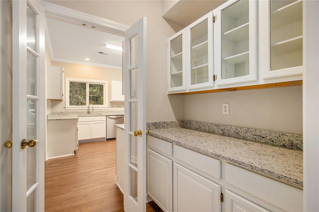 1463 Crescent Walk Decatur, GA 30033 - Photo 10 of 28 a view of a kitchen with a sink dishwasher stove and cabinets