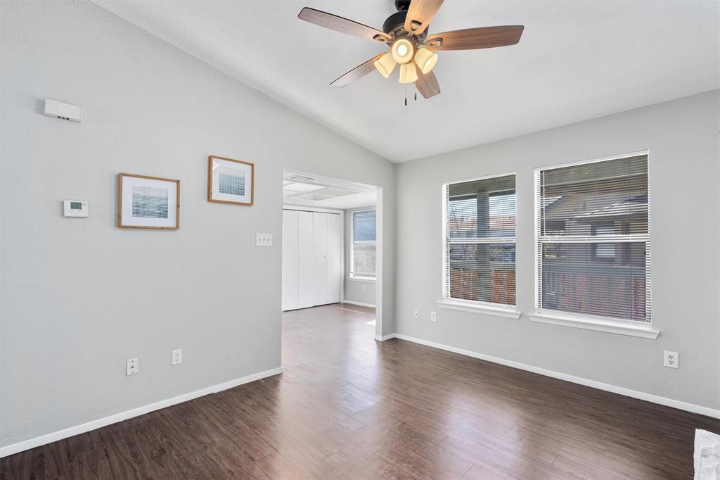 1711 Rawhide Loop Round Rock, TX 78681 - Photo 4 of 14 Spare room featuring lofted ceiling, dark wood-style floors, and a ceiling fan