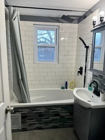 a bathroom with a sink a mirror and a shower