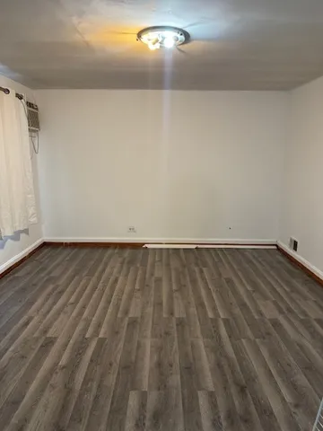 a view of a room with wooden floor