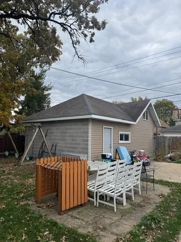 a backyard of a house with table and chairs