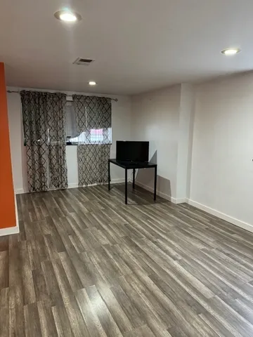 a view of a livingroom with furniture and wooden floor