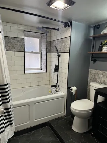 a bathroom with a toilet a sink and a mirror