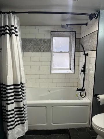 a bathroom with a bathtub and a shower