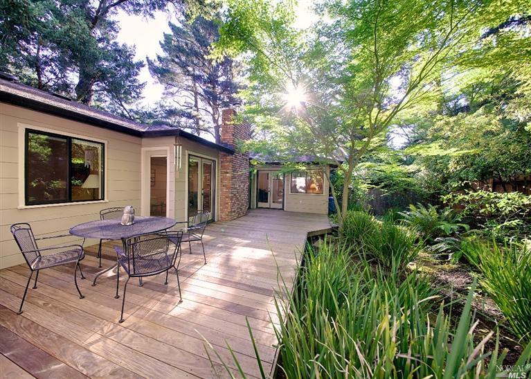 a backyard of a house with outdoor seating