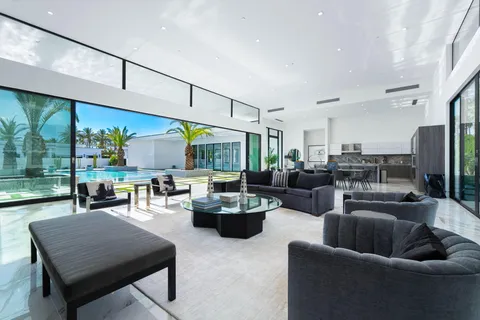 a living room with furniture and large windows