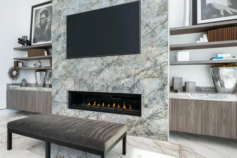 a kitchen with stainless steel appliances kitchen island granite countertop a kitchen island and chairs in it